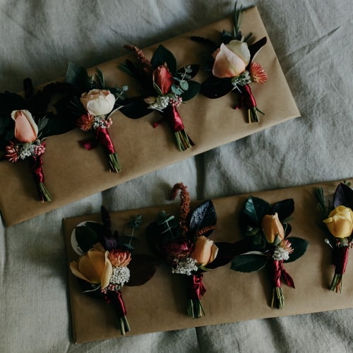 eight boutonnieres on two kraft paper boards
